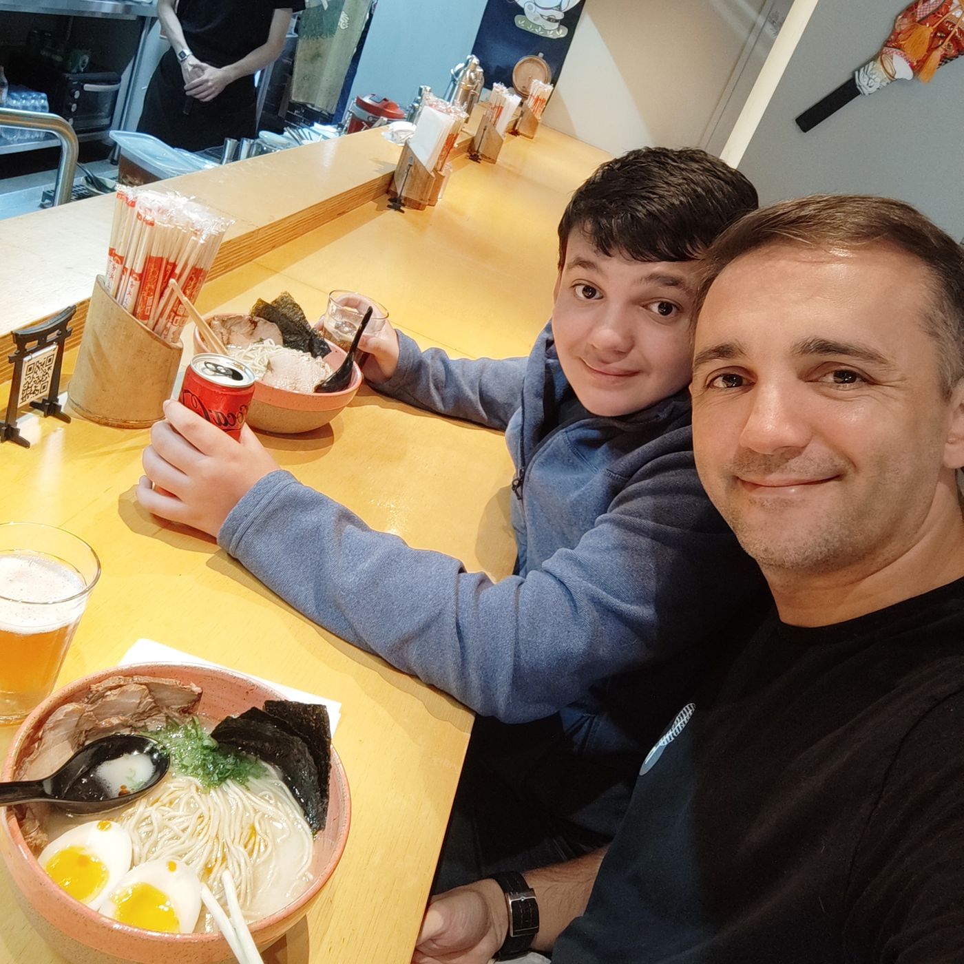 Felipe and his son Davi at a ramen counter